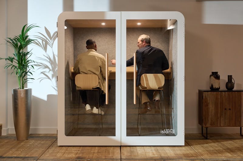 A couple of men sitting at a table in a room