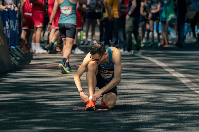 Runner ties his shoe before a race.