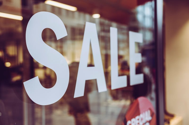 a close up of a sale sign in a store window