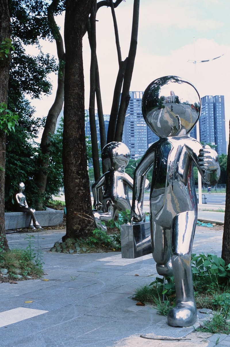 A metal statue of a person holding a baby