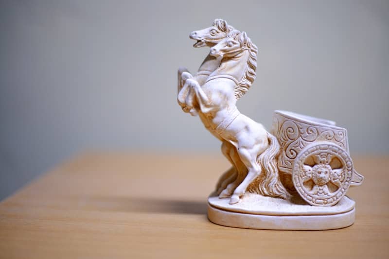 A decorative statue of a horse and chariot.