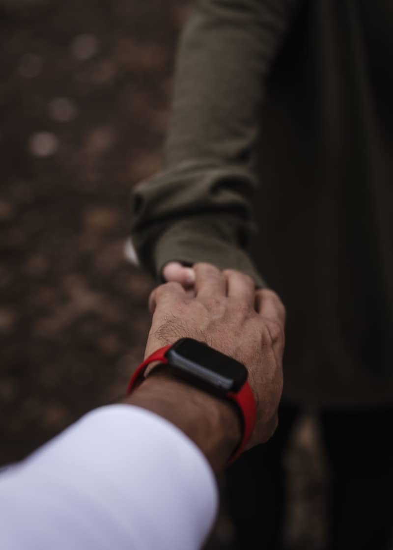 A couple of people holding hands while standing next to each other