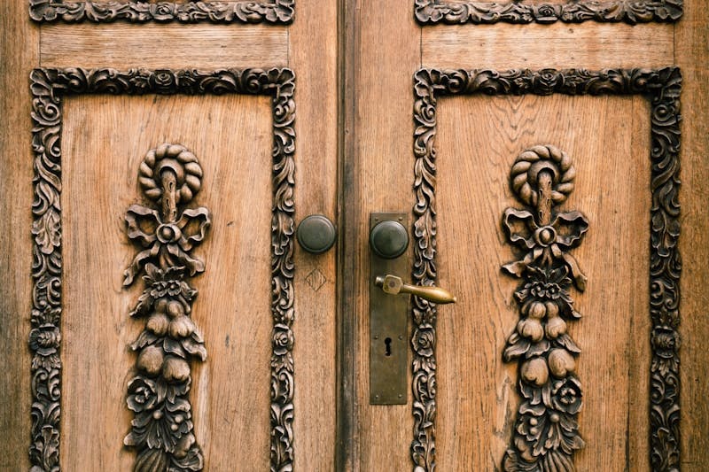 A close up of a wooden door with carvings on it