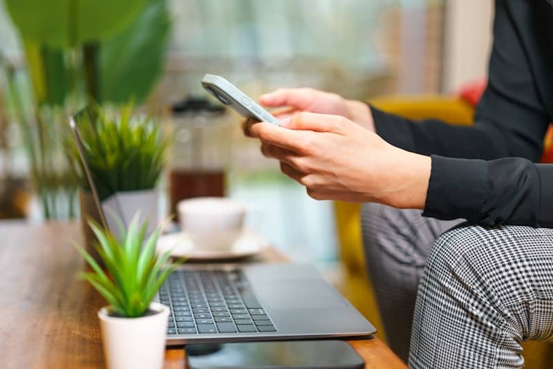 A person sitting on a couch using a cell phone