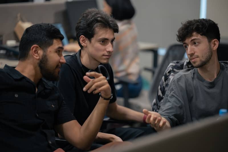 A group of men sitting next to each other