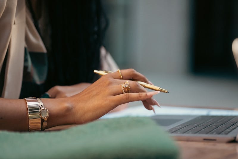 A woman sitting at a table with a laptop computer