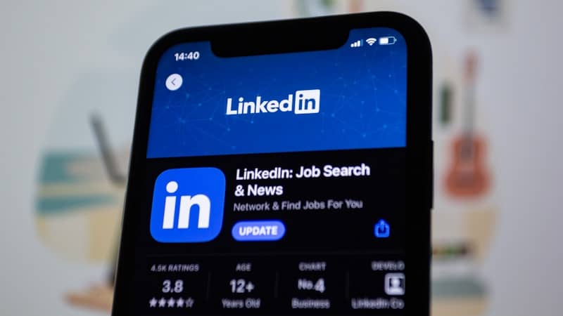 the linkedin logo is displayed on a smartphone