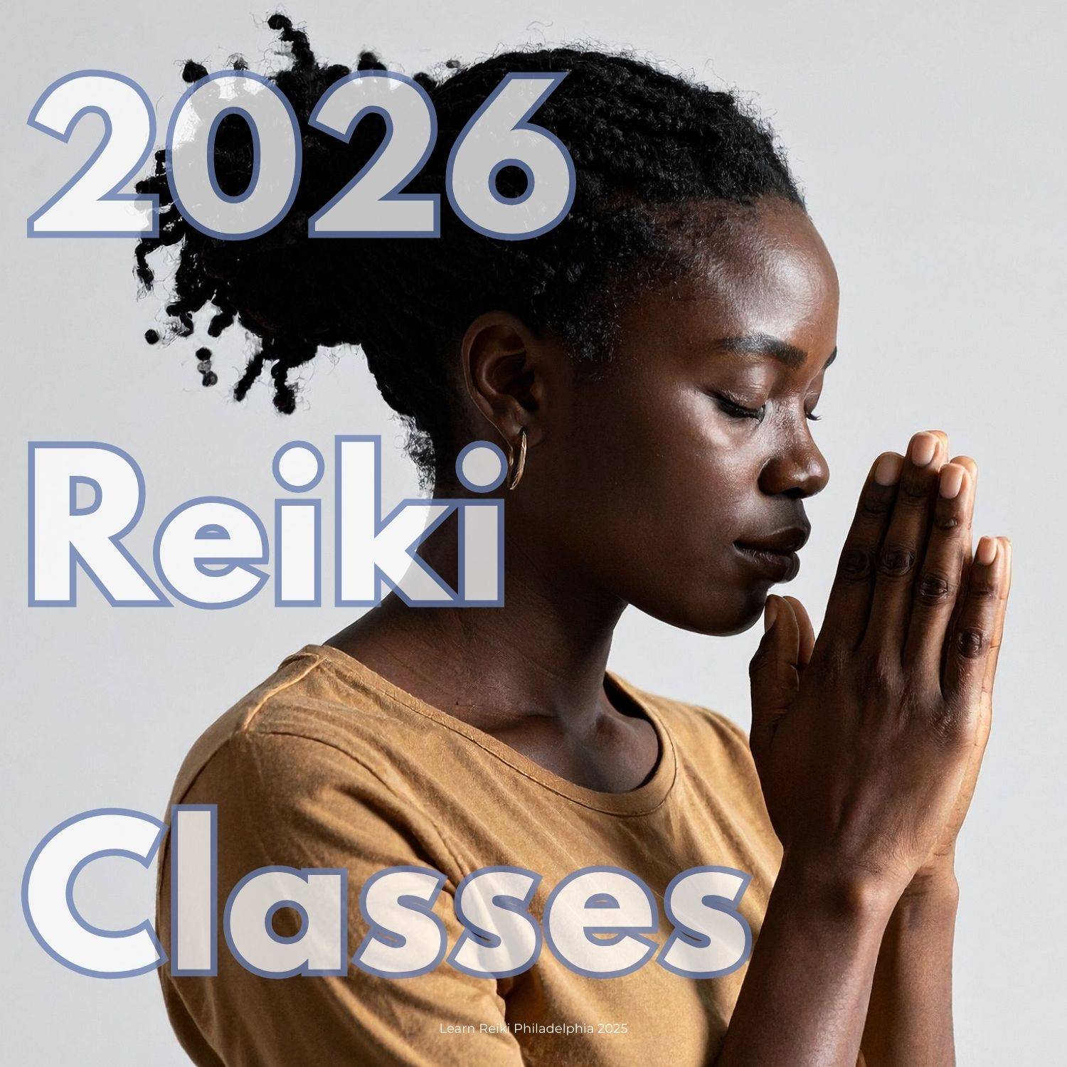 Black woman with hair pulled back and eyes closed in prayer position, known as gassho in the Usui Reiki Tradition with letters reading "2026 reiki classes"