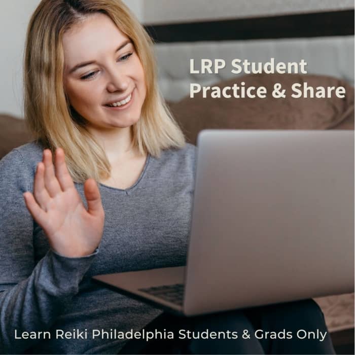 A white woman with blonde hair sits down, waving at a computer camera