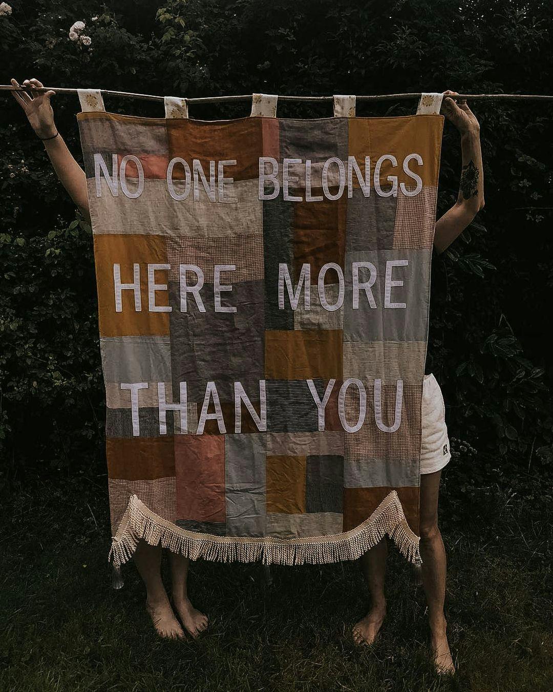 Quilt that says, "No one belongs here more than you"