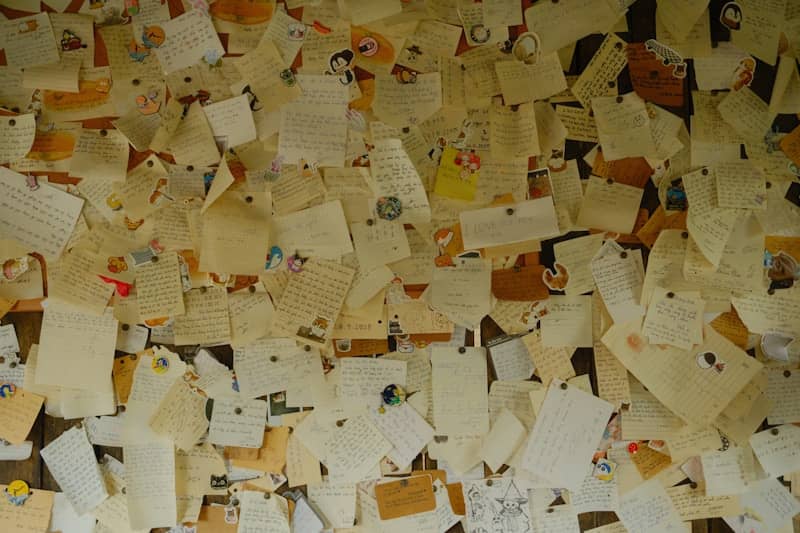Wall covered with many pinned letters and notes