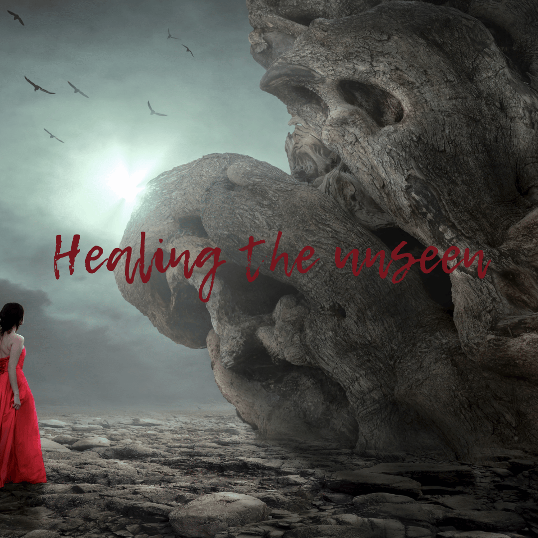 A woman in a red dress stands on a rocky landscape, facing a large, weathered rock formation resembling a face. The sky is overcast with a flock of birds flying, and light breaks through the clouds. The words "Healing the unseen" are overlaid in red script across the image.
