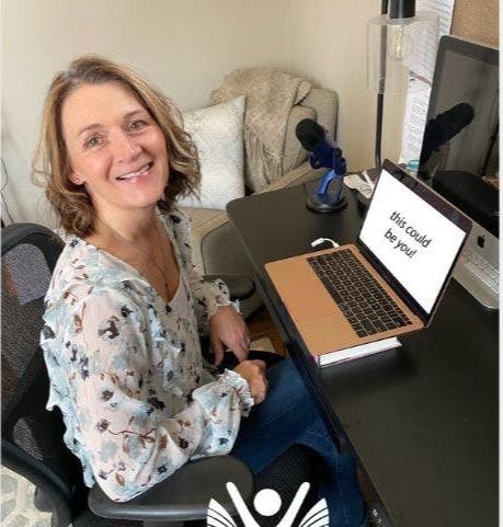 Anita Perrigo sitting at her desk.  The caption 'this could be you' is written on her laptop.