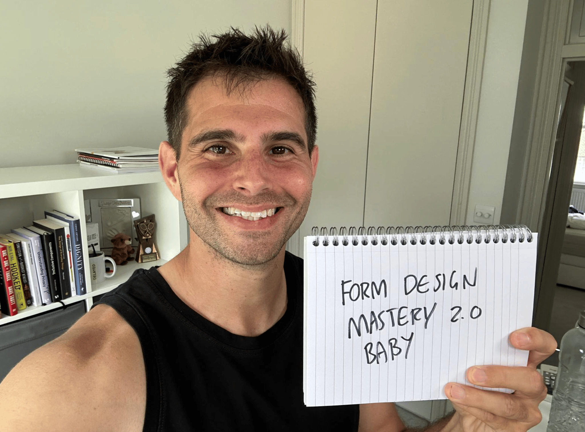 Me holding a sign saying Form Design Mastery 2.0 baby