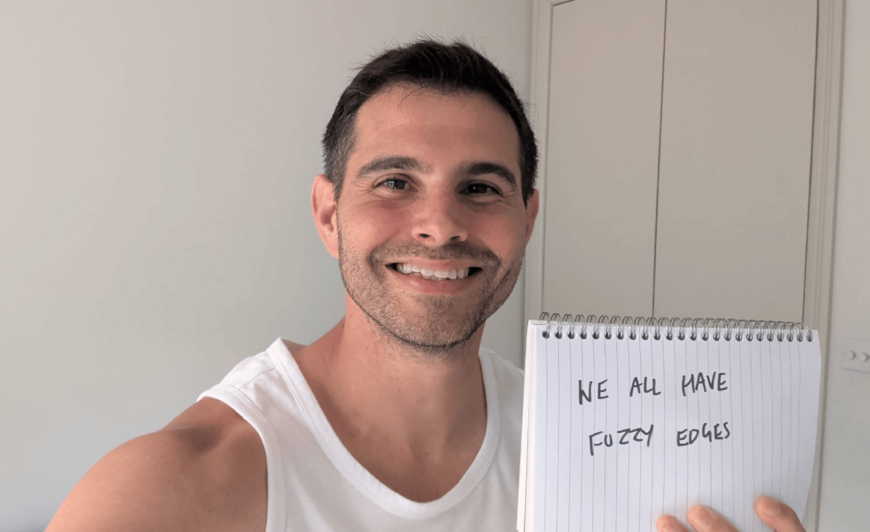 Me holding a sign saying, "We all have fuzzy edges."