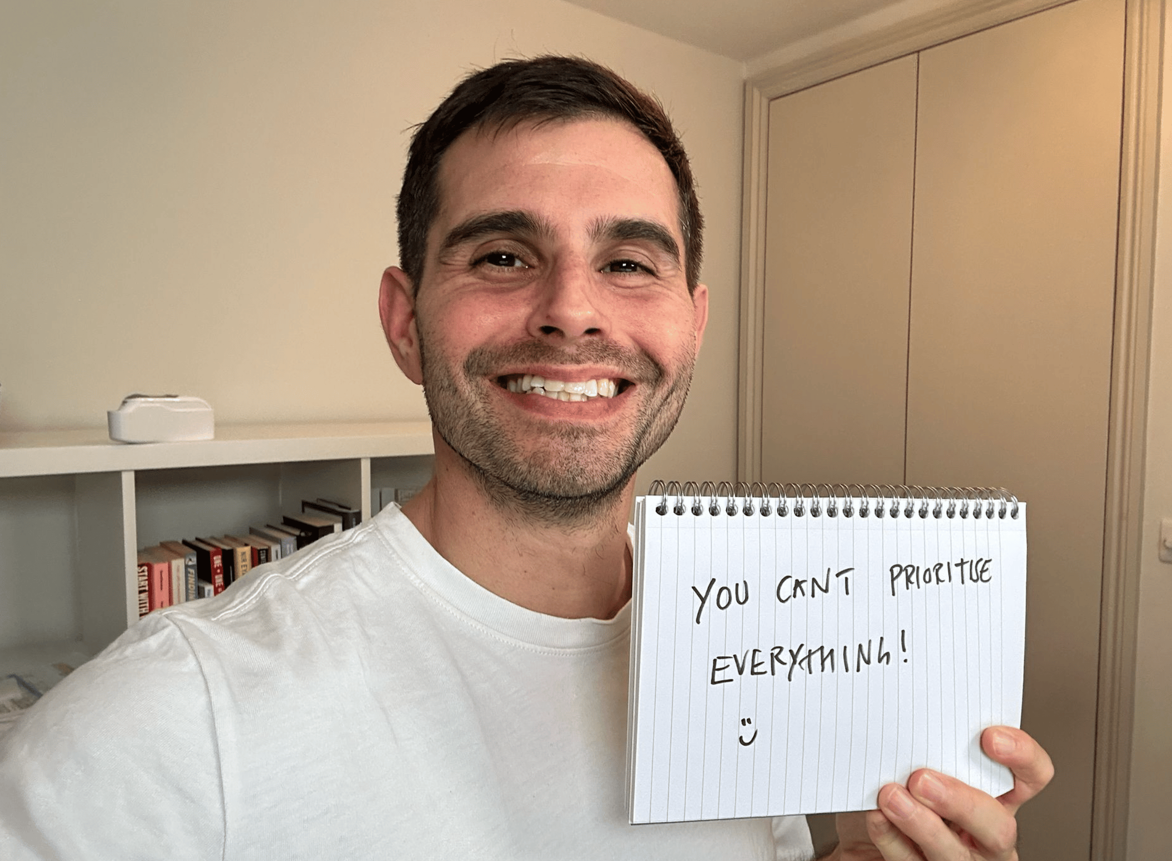 Me holding a sign saying: you can't prioritise everything.