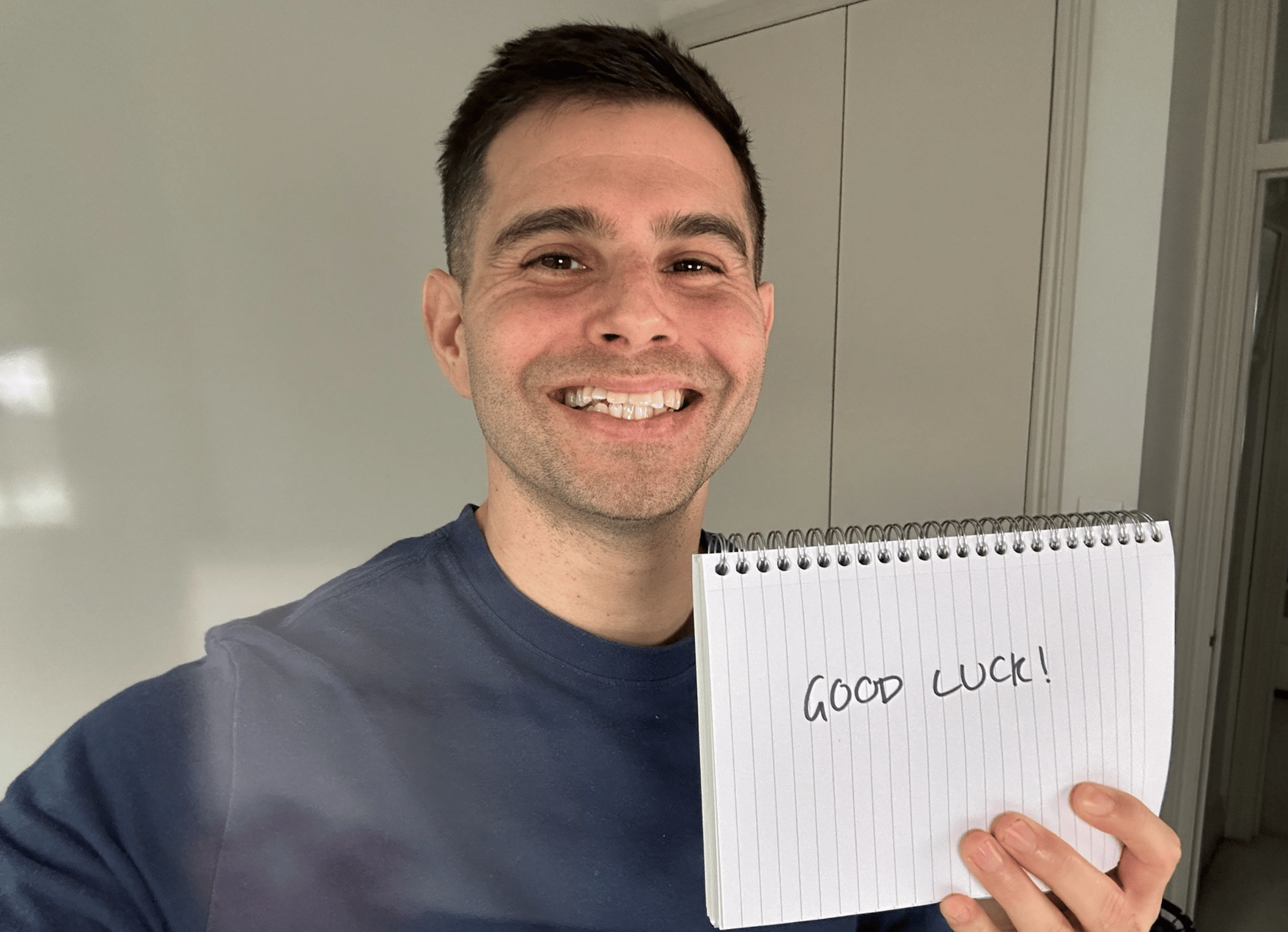 Me holding a sign saying good luck.