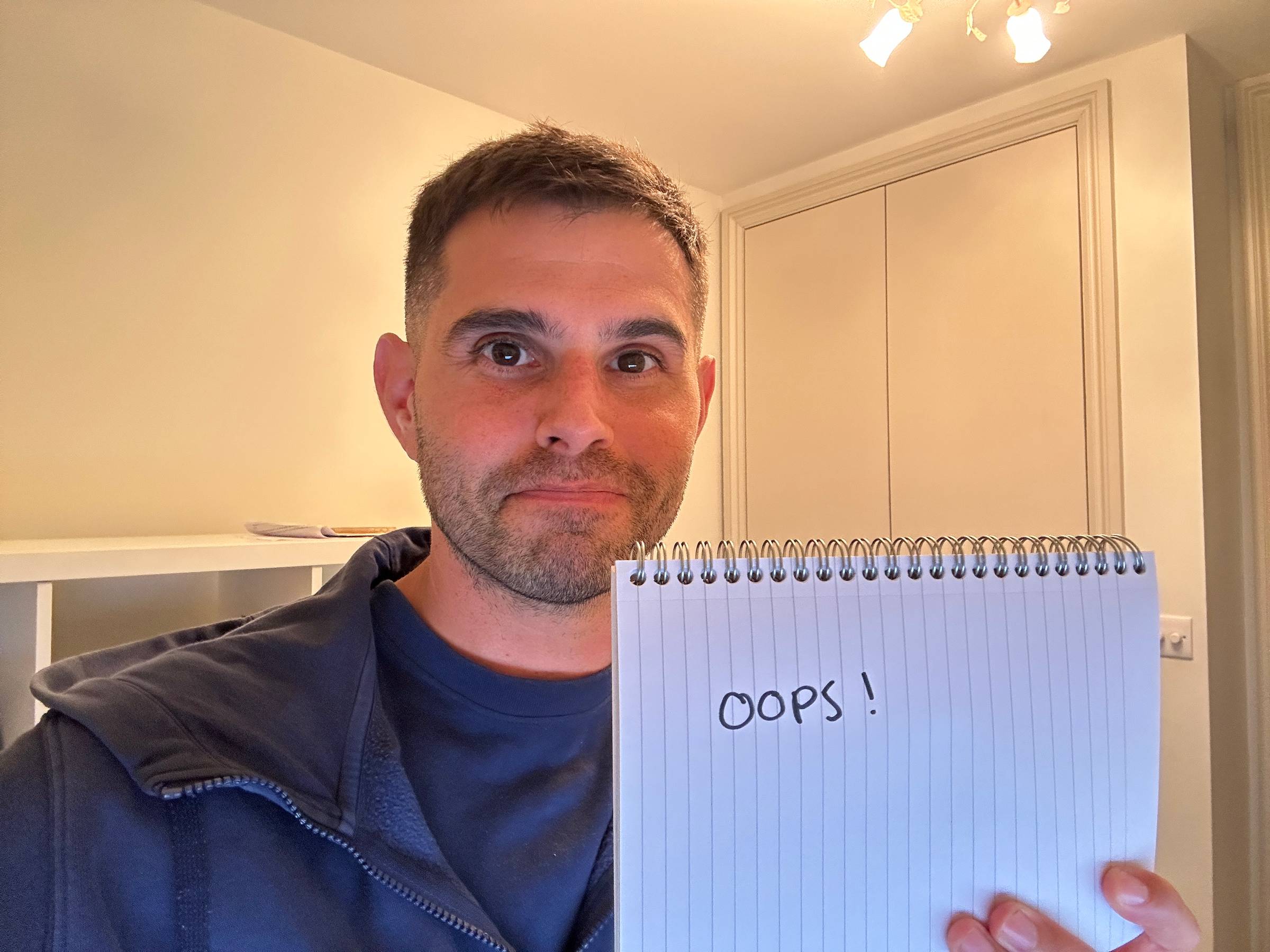 Me holding a sign saying "oops"