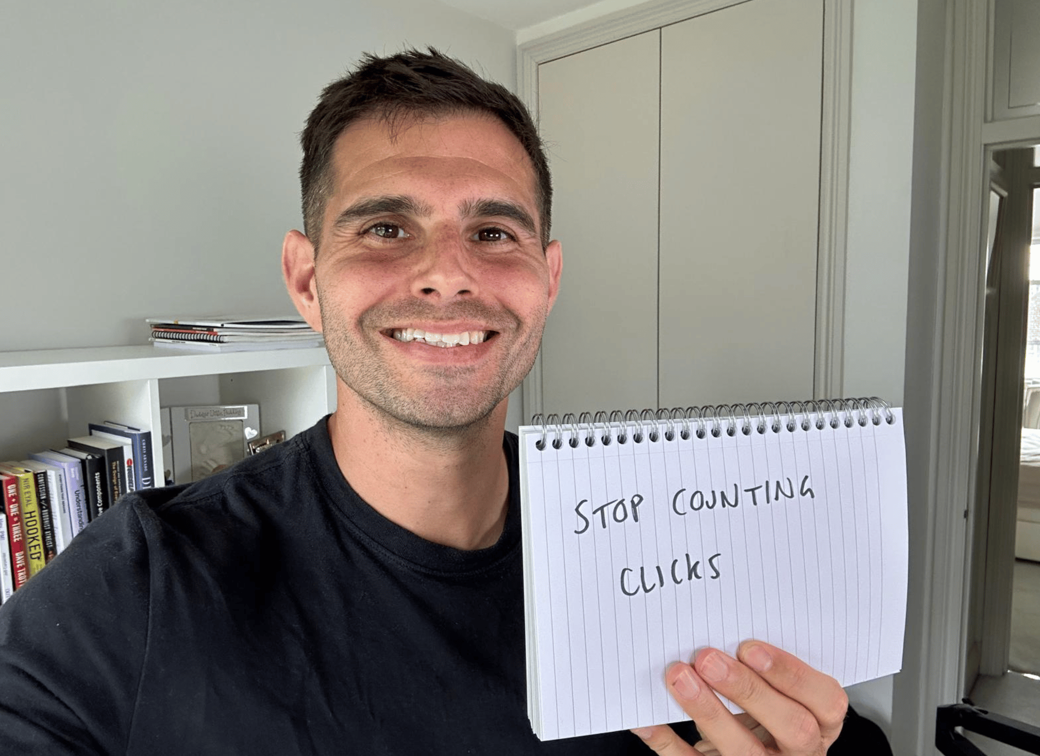 Me holding a sign saying "stop counting clicks"