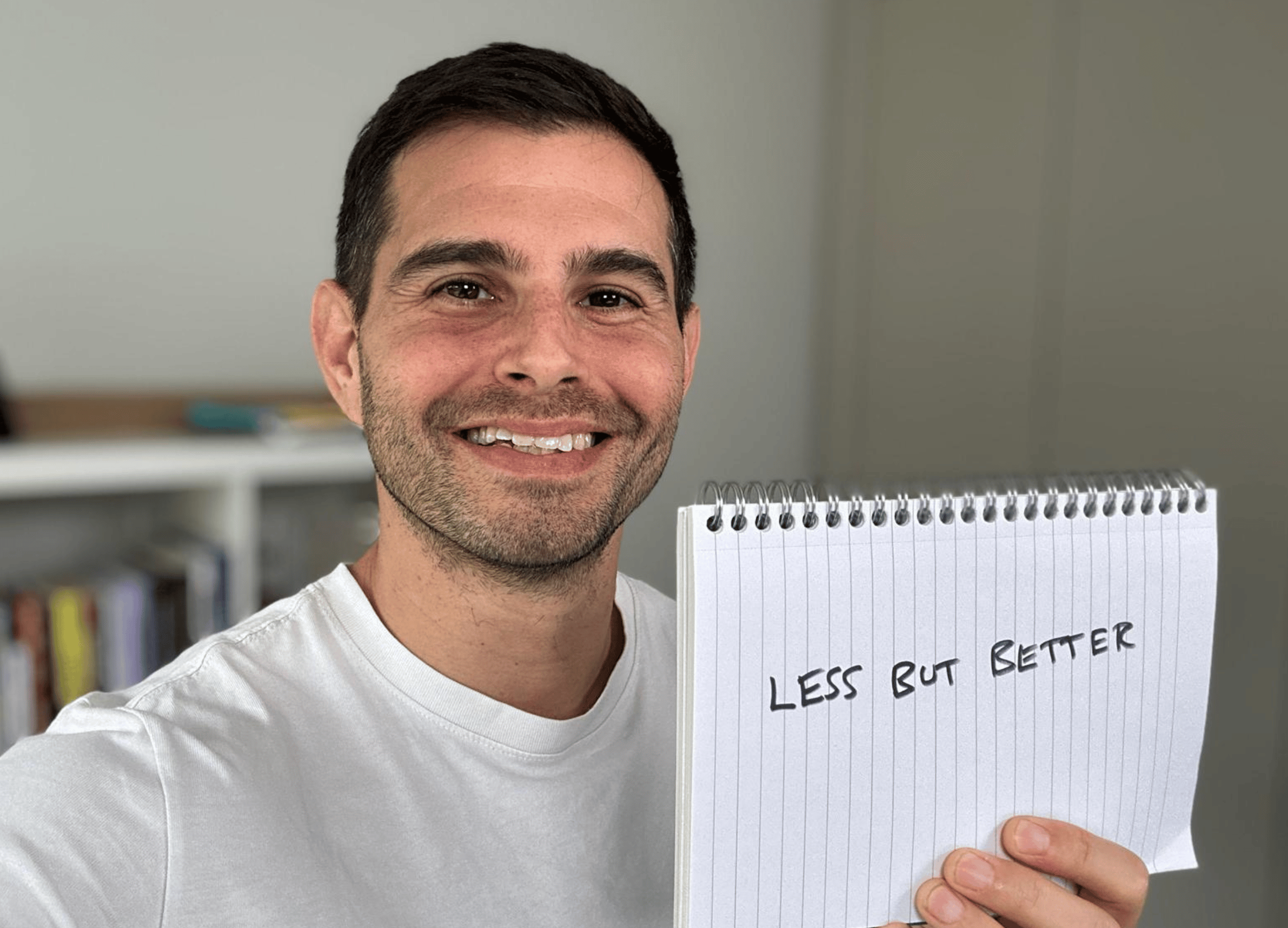 Me holding a sign saying less but better