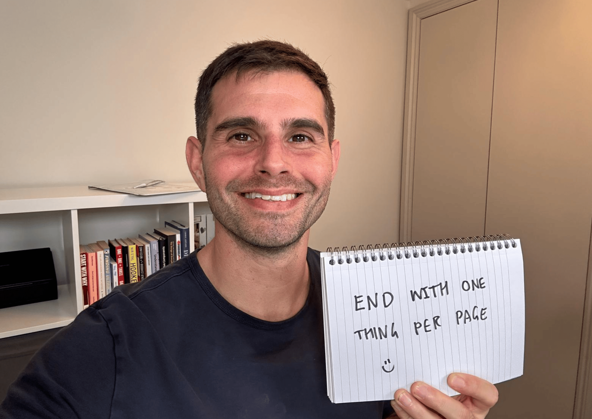 Me holding a sign that says: End with one thing per page