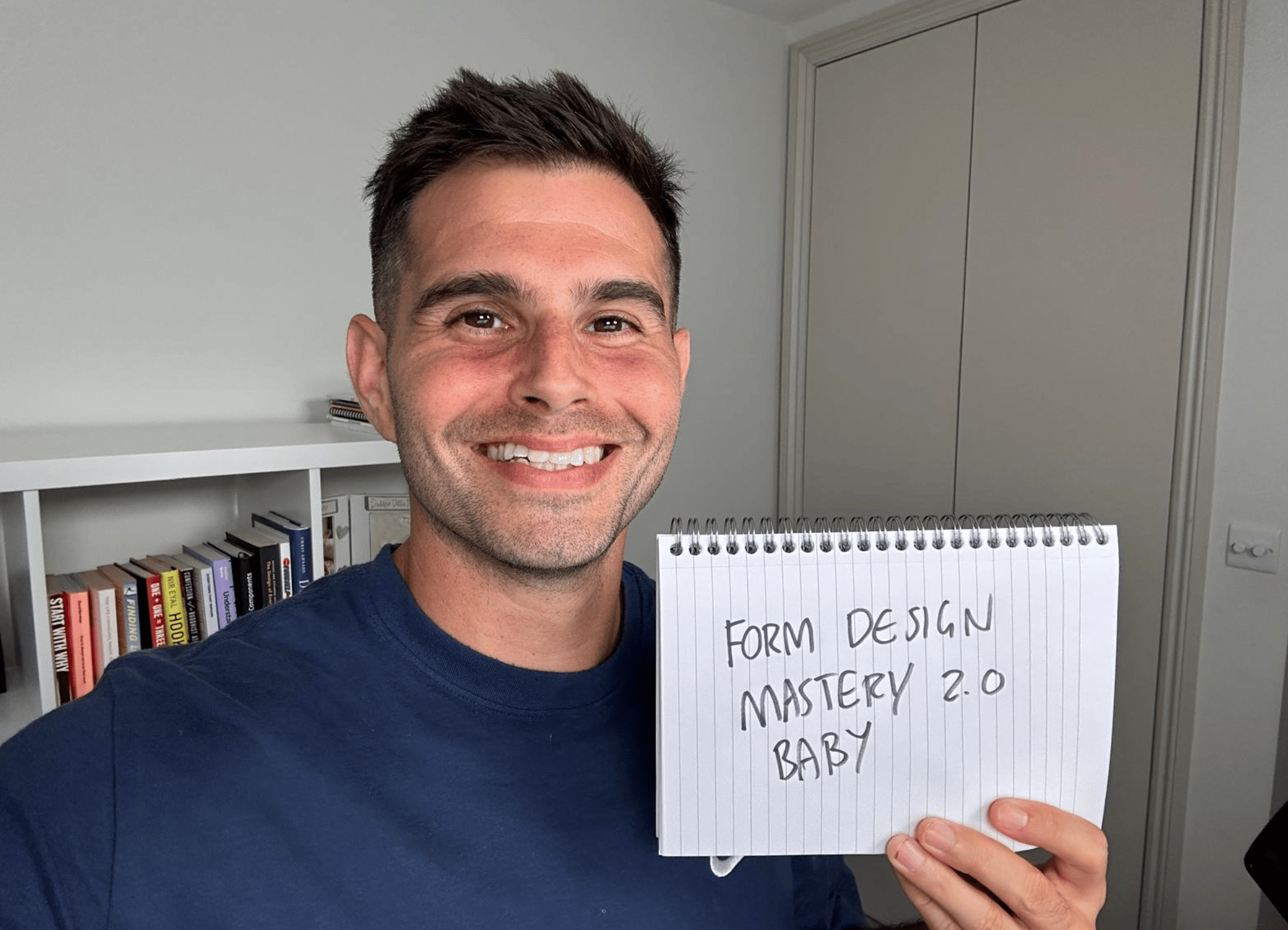 Me holding a sign saying Form Design Mastery 2.0 baby