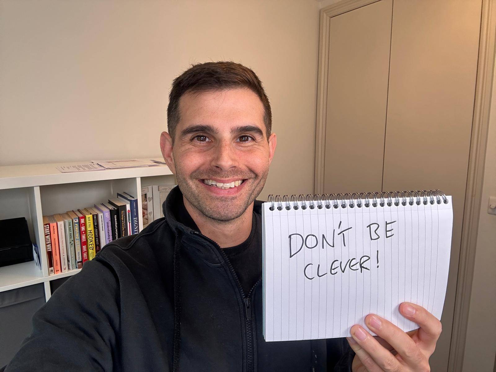 Me holding a sign saying don't be clever.