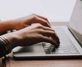 person sitting front of laptop