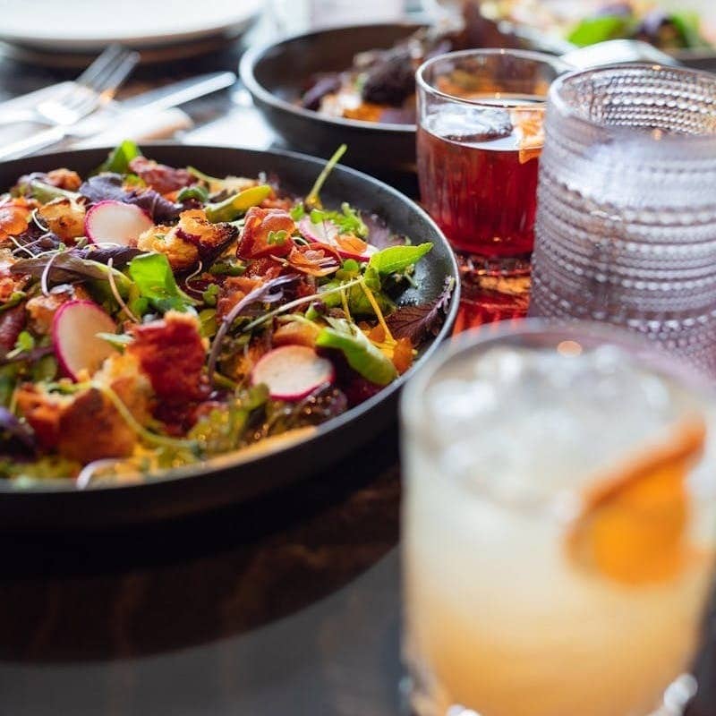 A table topped with plates of food and drinks
