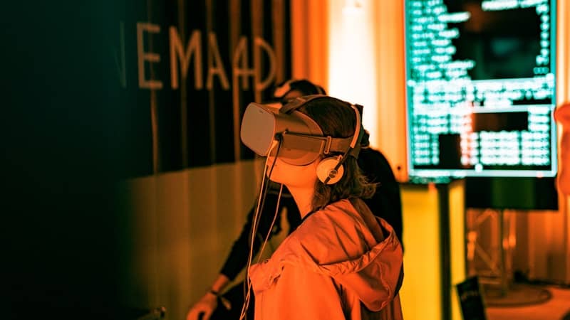 Woman in VR headset. Lights in the background.