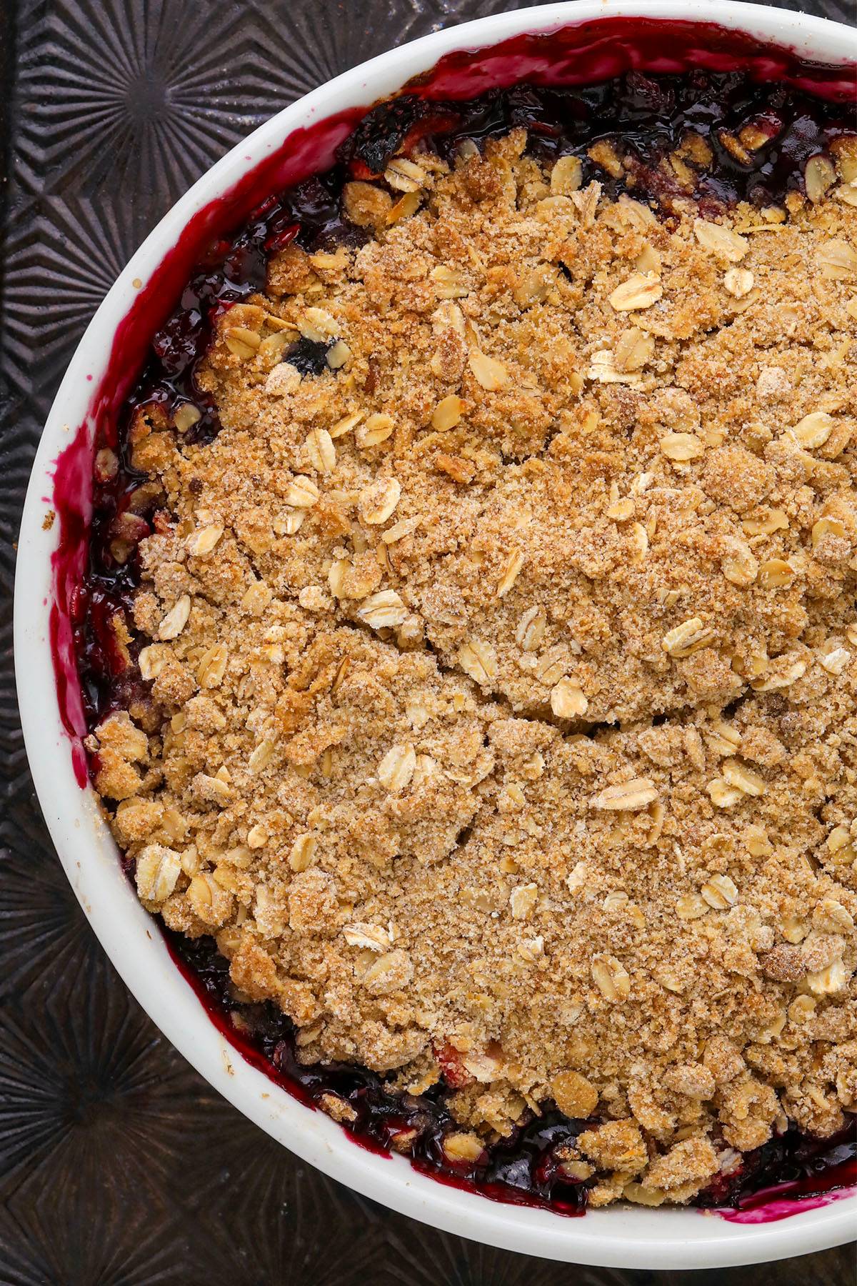 mixed berry crisp in a white dish