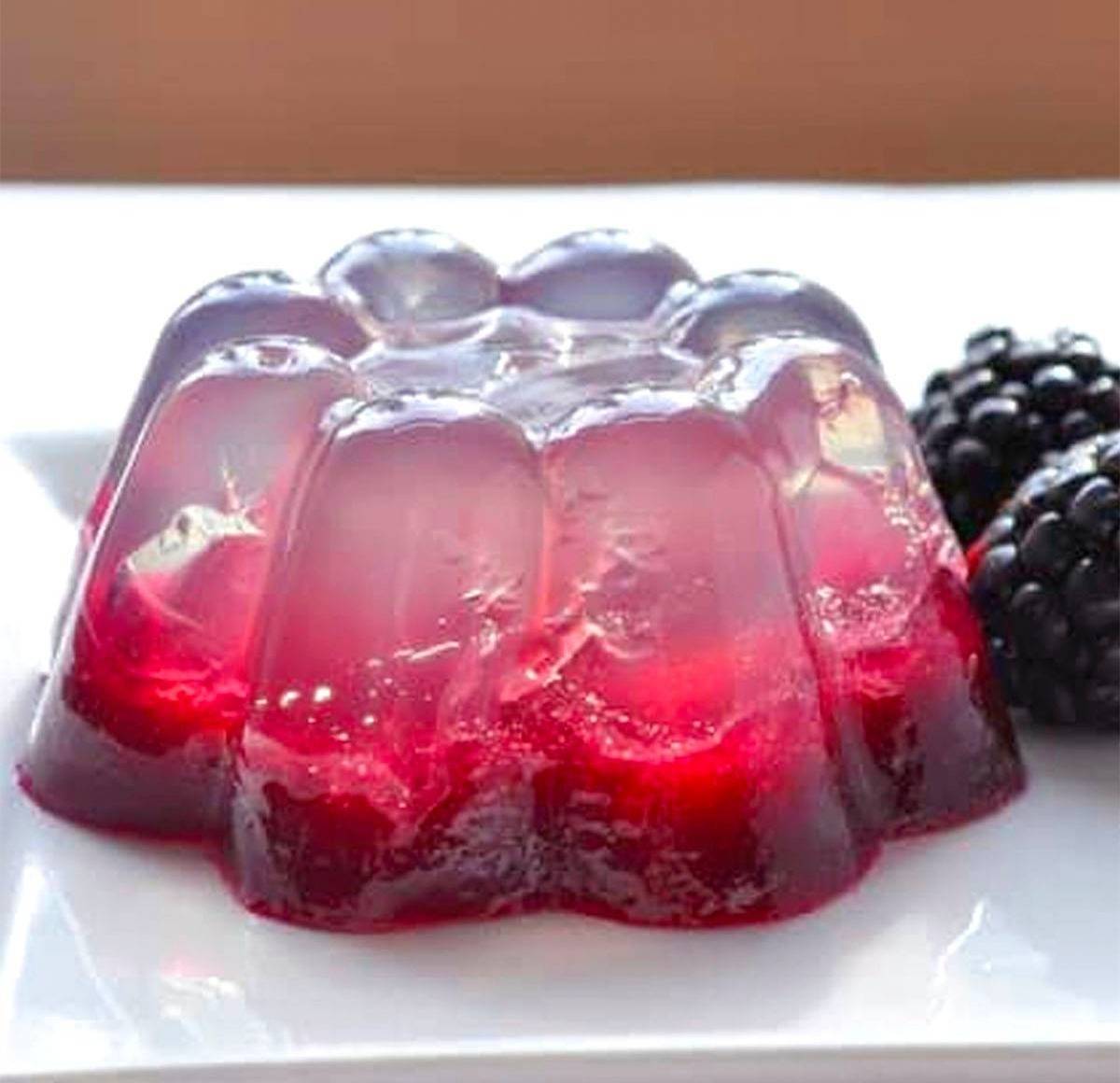 coconut water gelatin in a white plate with fresh berries