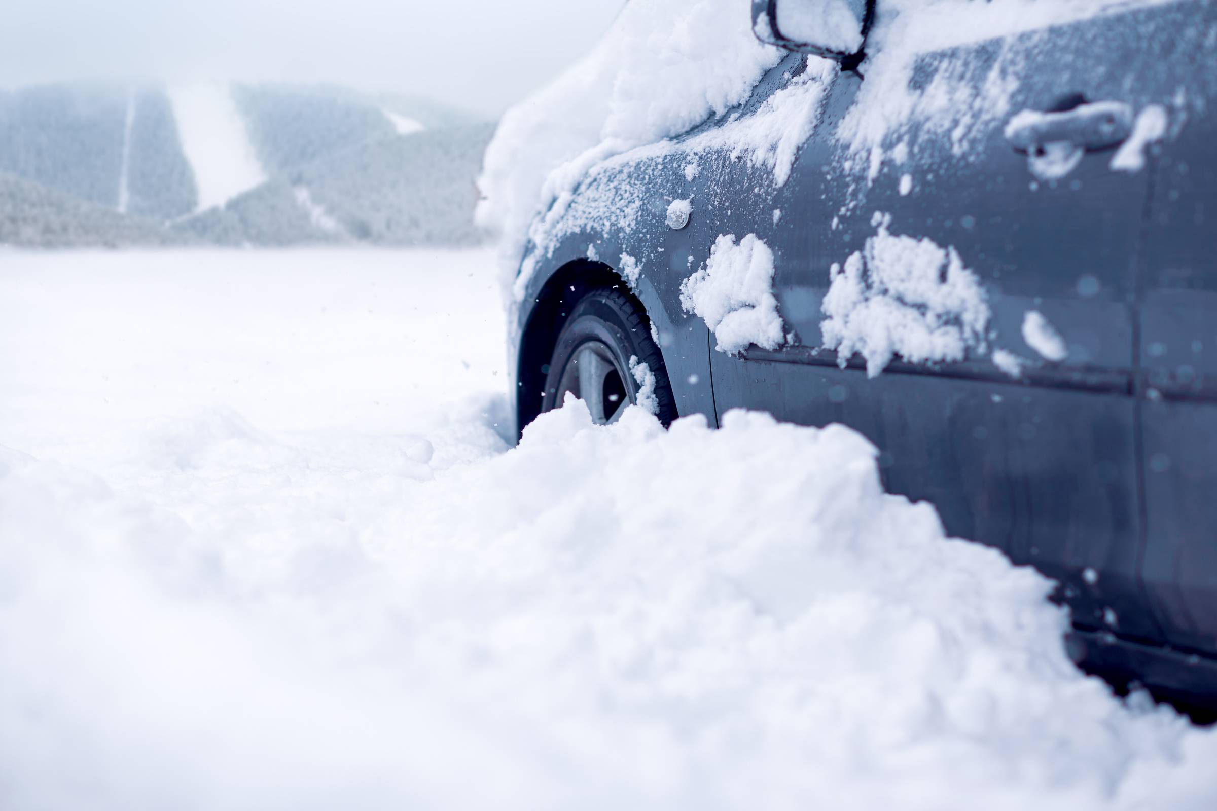 Snow covered car on a winter day.Frozen car covered snow at winter day