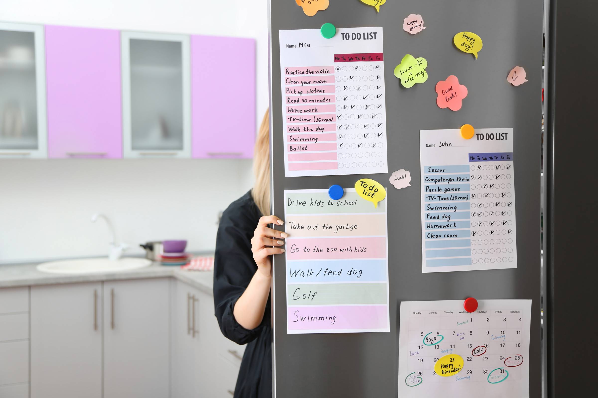 Calendar and to do lists hanging on refrigerator
