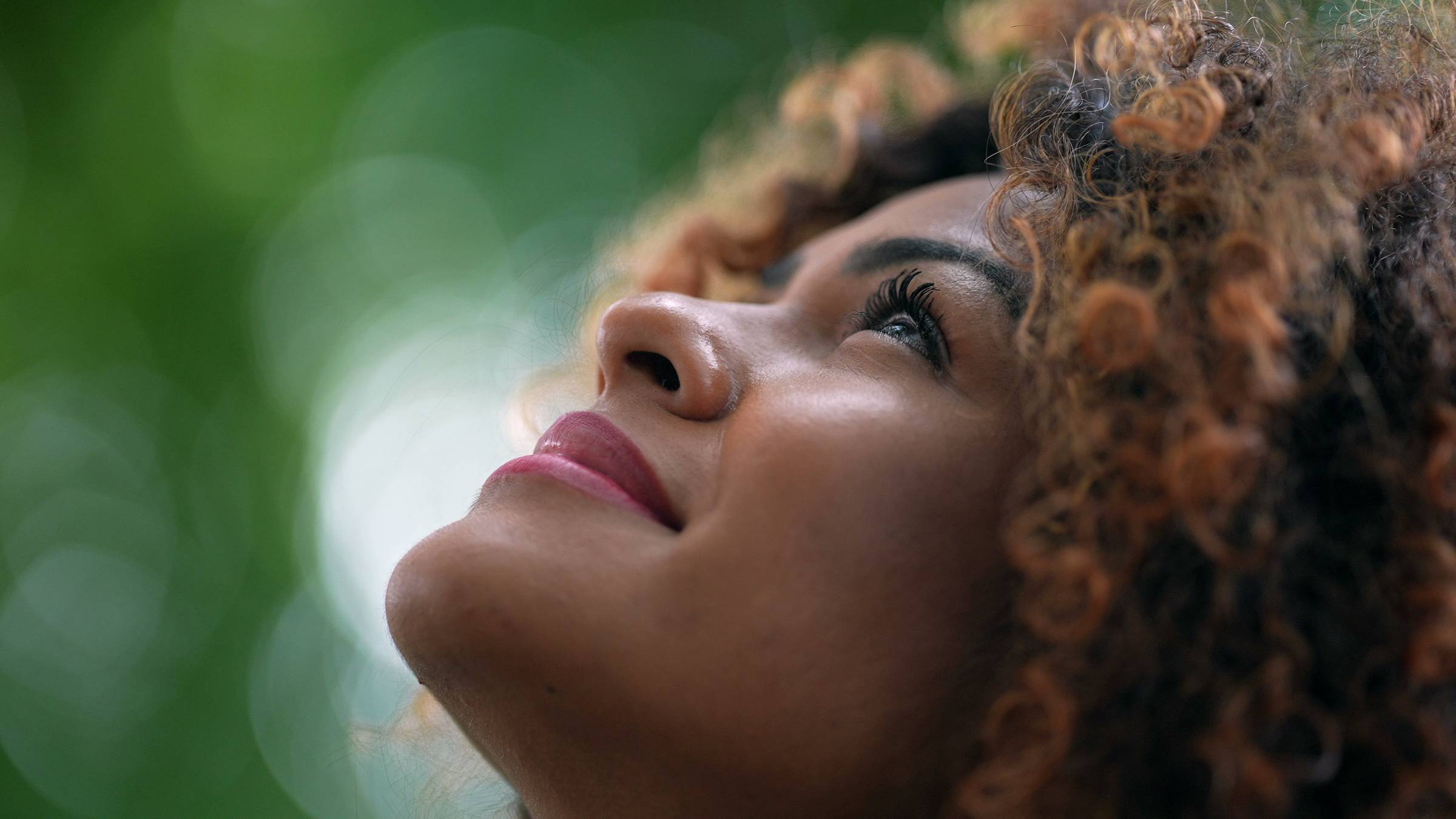 African woman looking up to sky