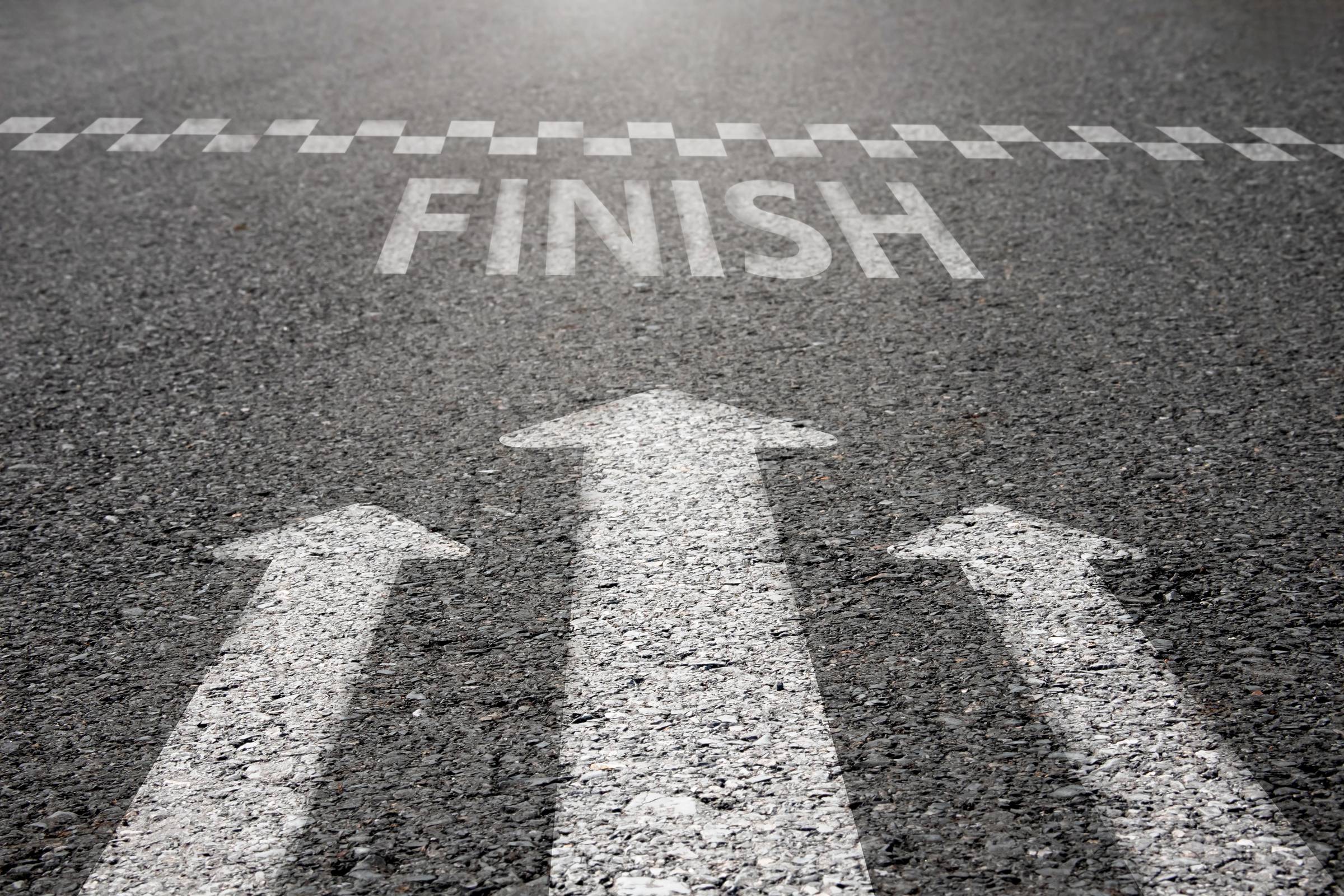    Arrow symbols dash forward to the finish line on the paved road. Downloaded    File #:  488499481 Arrow symbols dash forward to the finish line on the paved road.