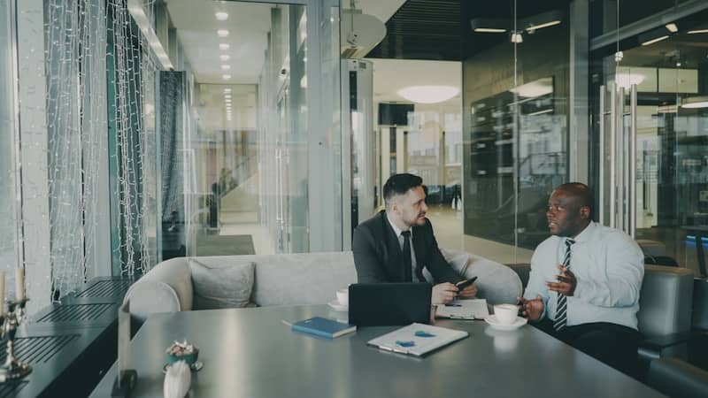Two businessmen talking at a table