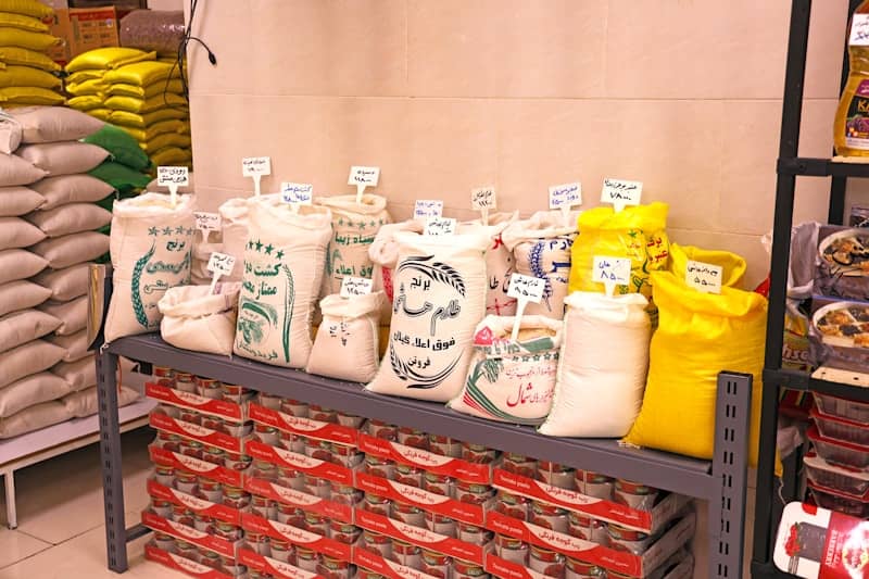 Bags of grains and food products displayed in a store.
