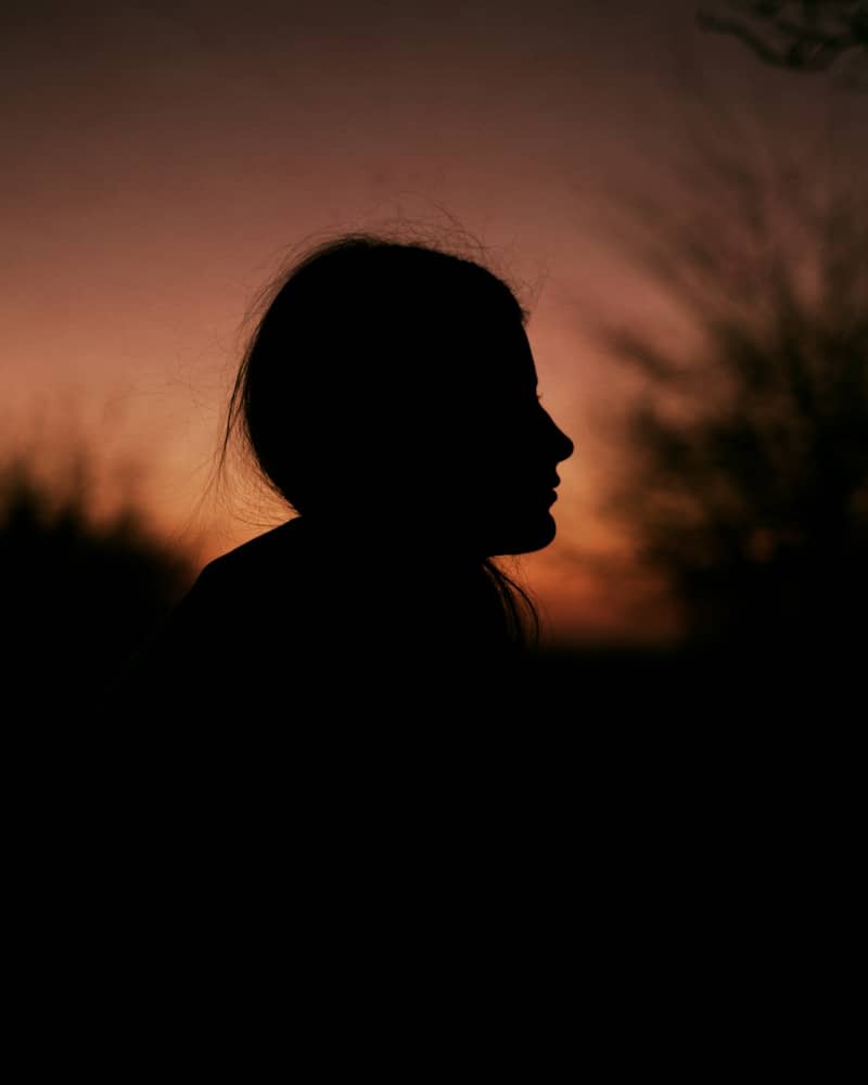 Silhouette of a young girl at sunset