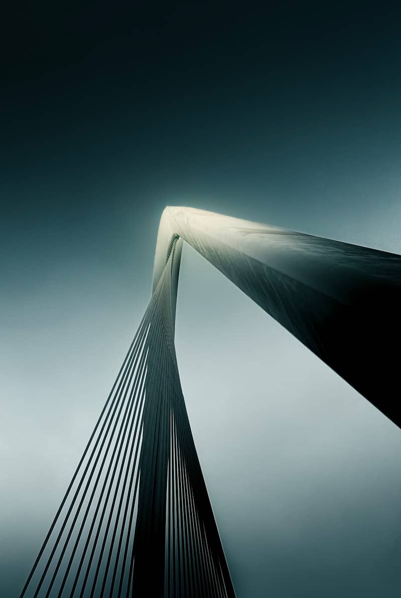 Bridge structure against a moody, overcast sky.