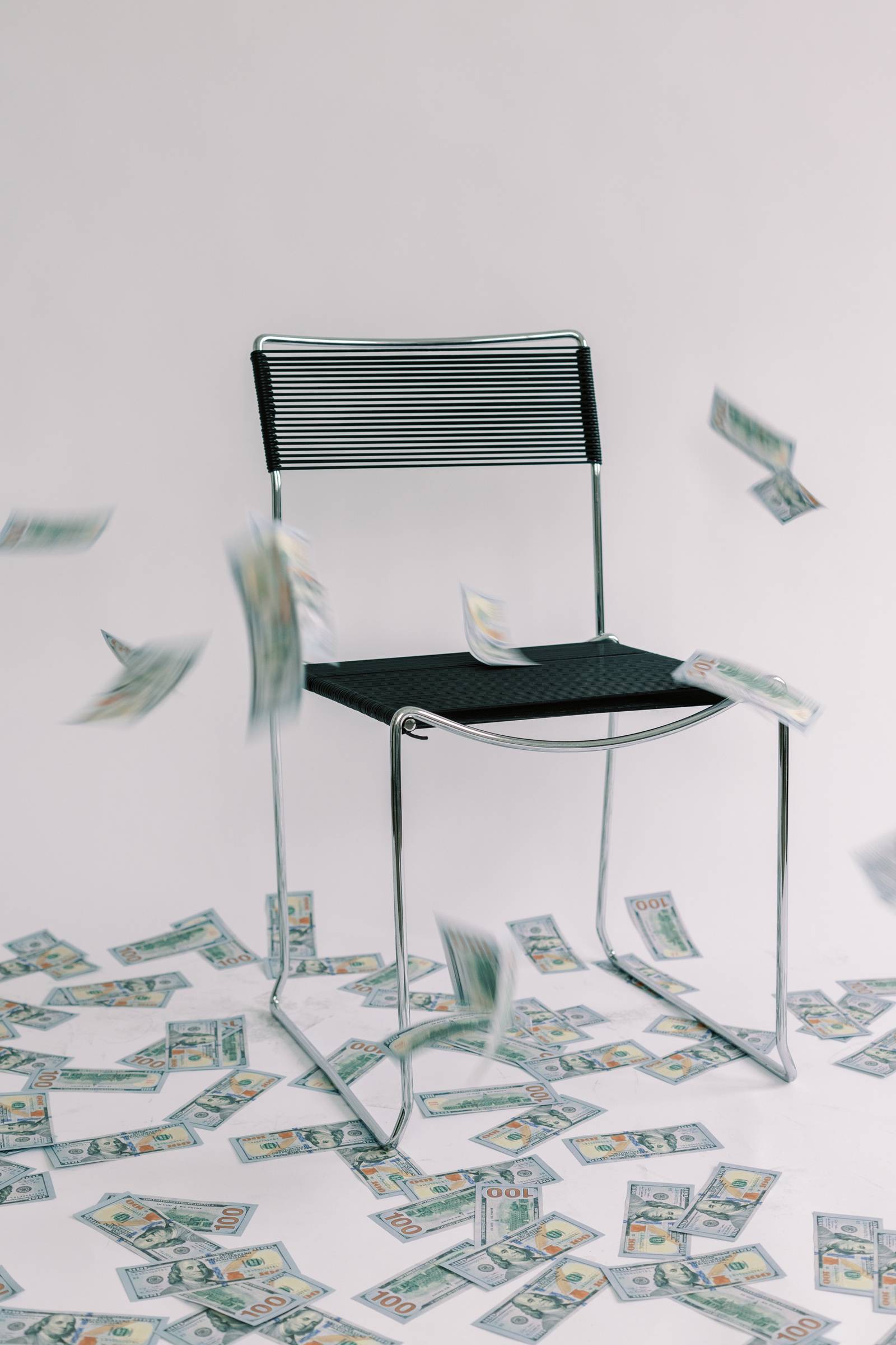 money being flying around a chair bc she made bank on her flows