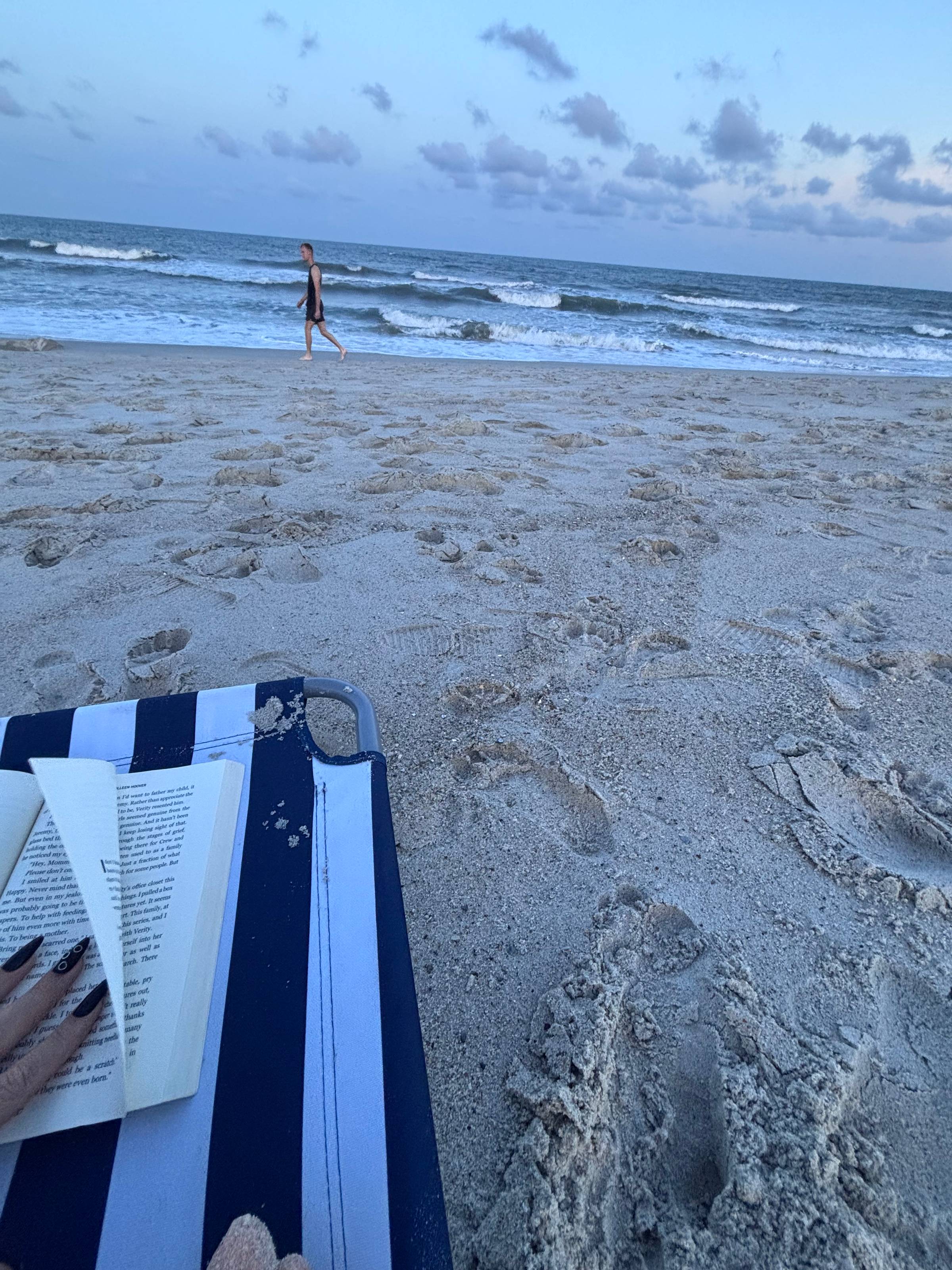 Image of a book open on the beach