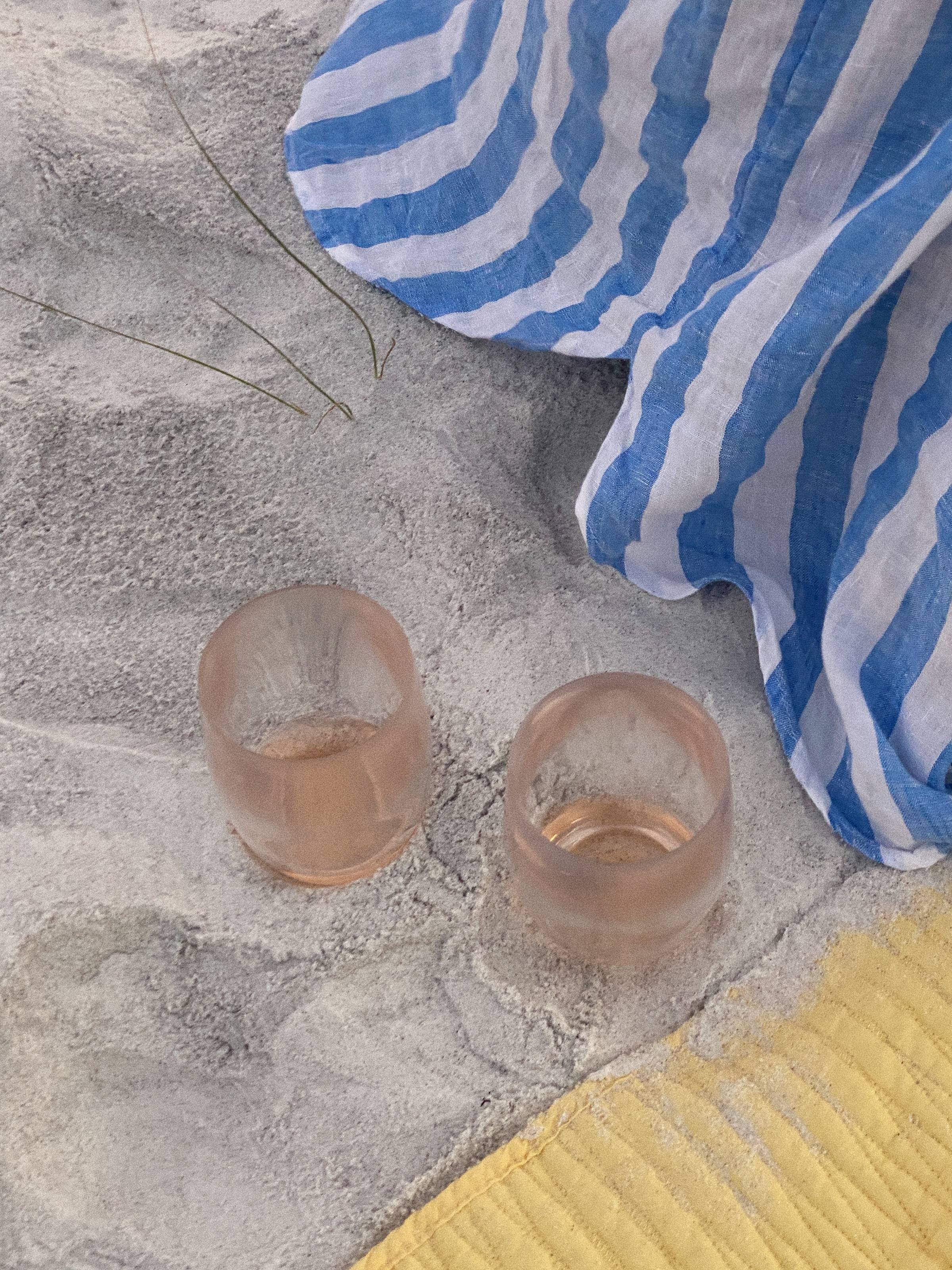 Image of cups in the sand