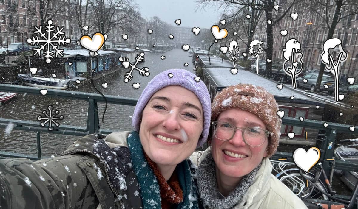 An image of me and my sister on  a snowy canal bridge in Amsterdam with CNVS icons decorated around the scene