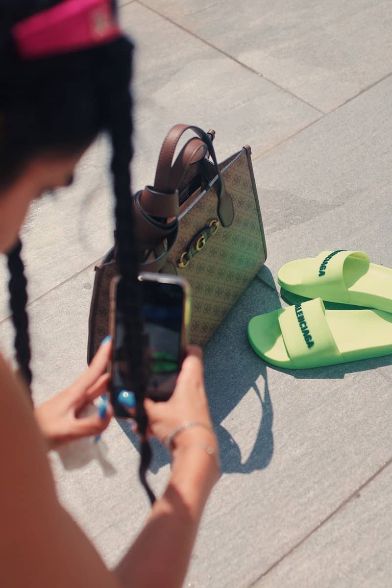 Woman taking picture of handbag and slides