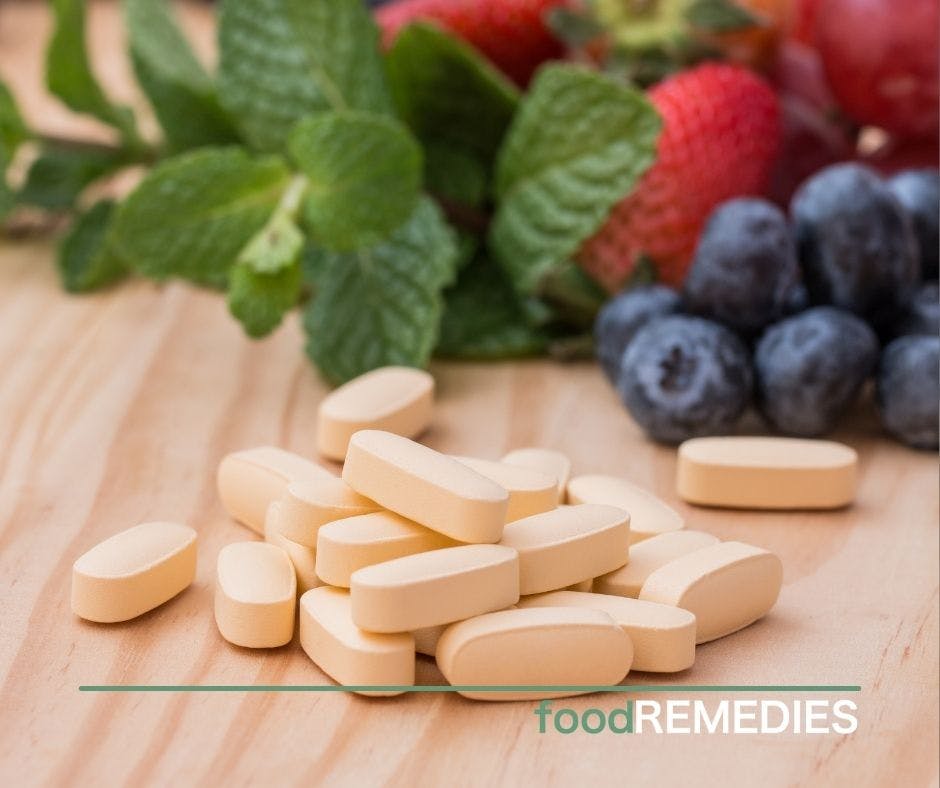 multivitamins and herbs and berries on the background