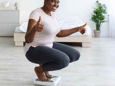 A happy woman on the scale