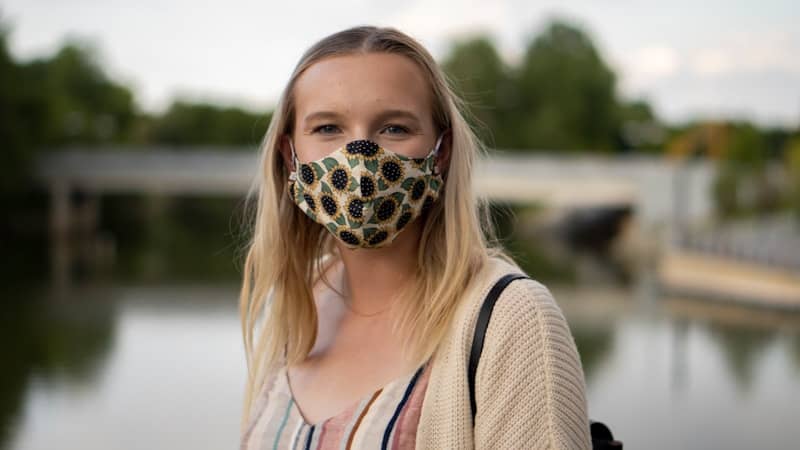 woman in white tank top wearing black and white skull mask