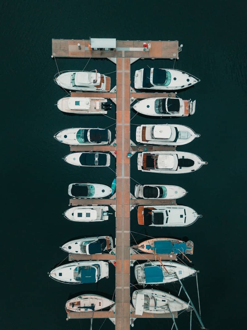 white and brown boat on body of water during daytime