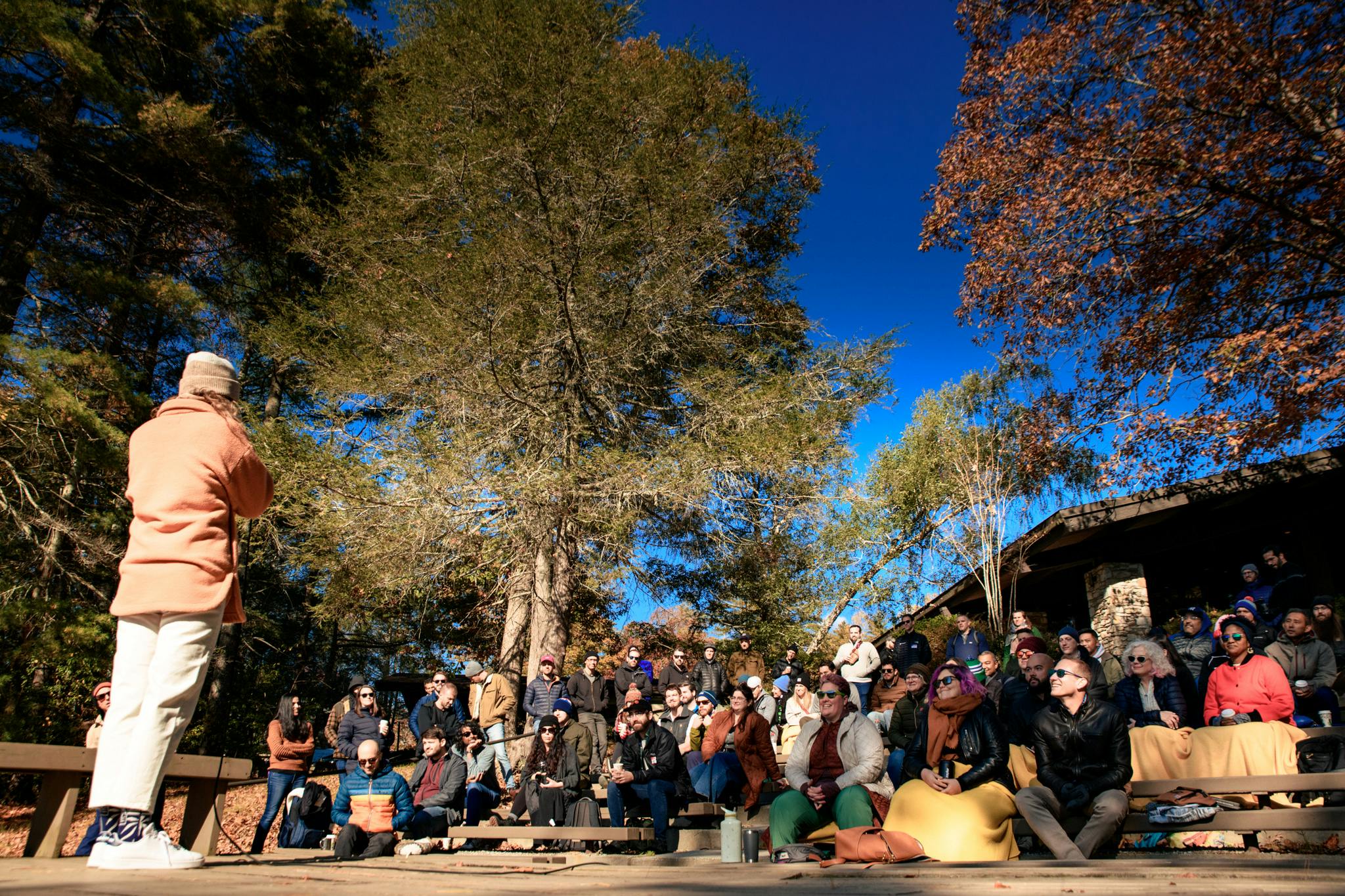 Group of people gathered under fall foliage